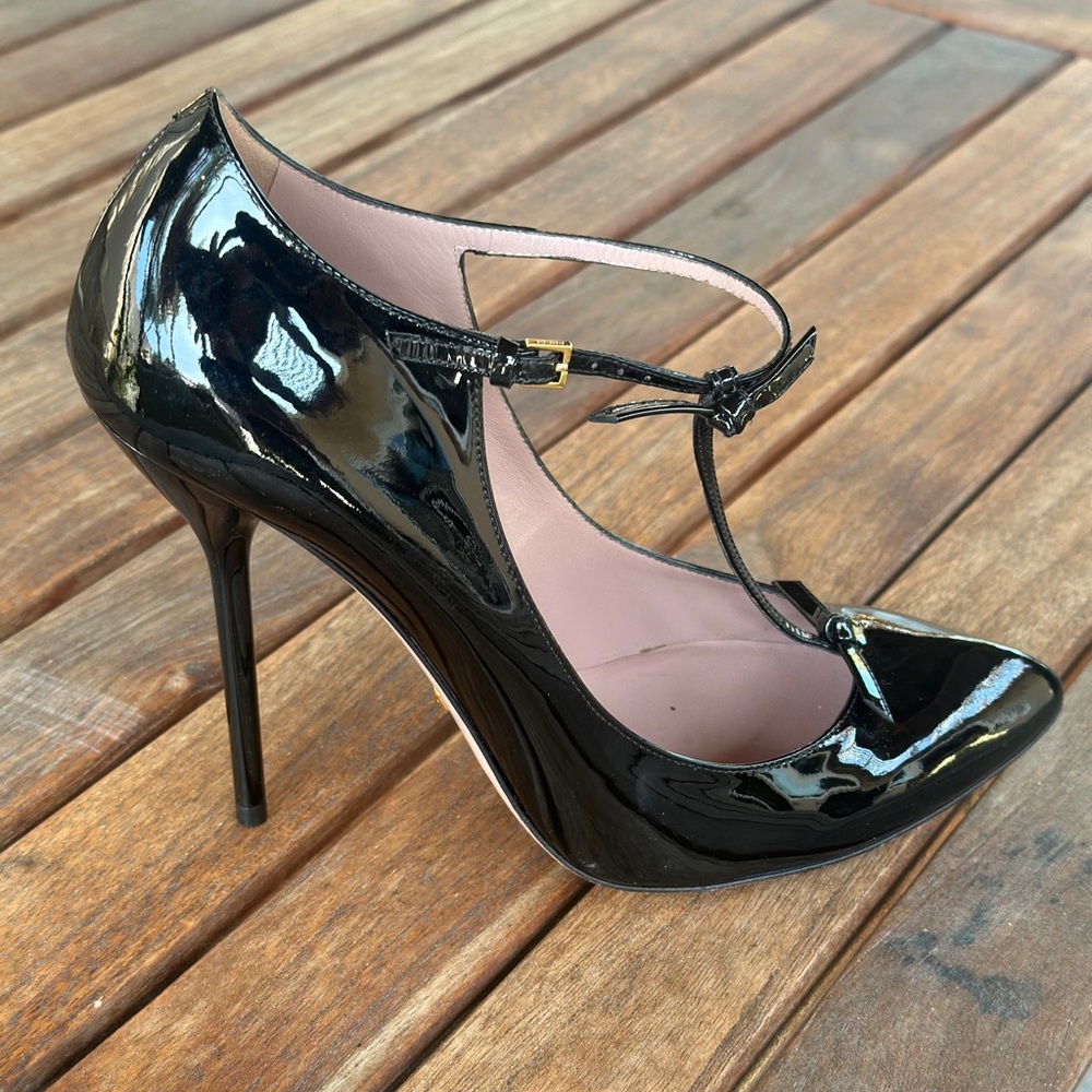 Gucci black patent leather t strap shoes.